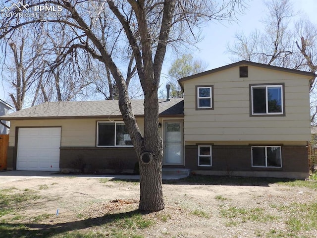 4555 N Anjelina Cir, Colorado Springs, CO 80916 - split level home featuring roof with shingles and a garage