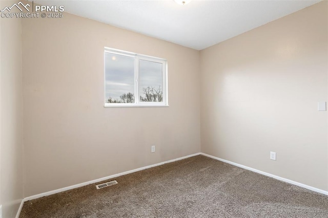 carpeted empty room featuring baseboards and visible vents