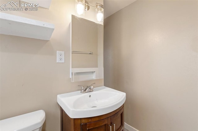 half bathroom featuring toilet and vanity
