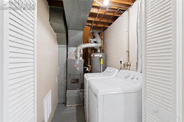 clothes washing area with heating unit, washer and dryer, water heater, laundry area, and visible vents