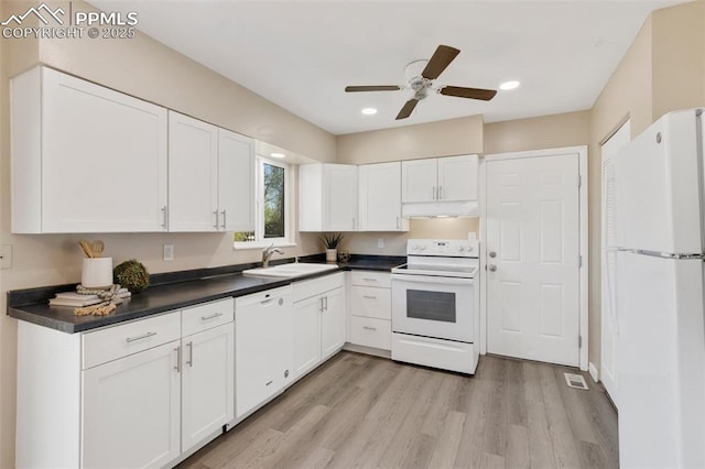 kitchen with a sink, dark countertops, white cabinetry, a ceiling fan, and white appliances