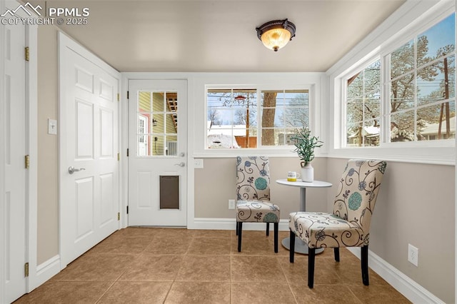 living area featuring baseboards and tile patterned flooring