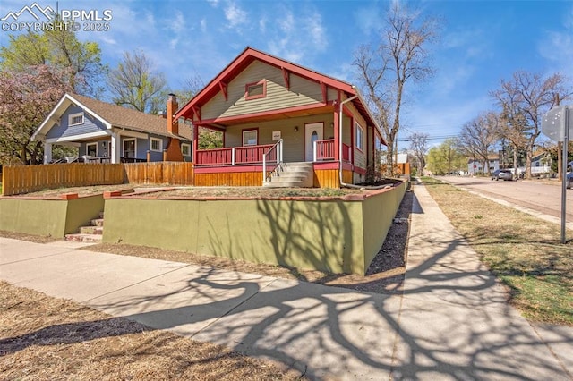 view of front of house with a porch and fence