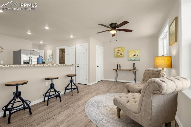 interior space with recessed lighting, ceiling fan, light wood-style flooring, and baseboards