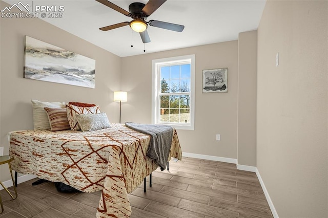 bedroom with wood finished floors, ceiling fan, and baseboards