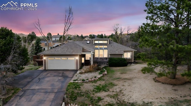 70 Palm Springs Dr, Colorado Springs, CO 80921 - view of front facade with asphalt driveway, a garage, and a shingled roof