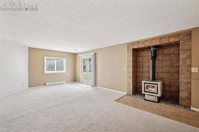 70 Palm Springs Dr, Colorado Springs, CO 80921 - unfurnished living room with a baseboard radiator, carpet flooring, a textured ceiling, a wood stove, and baseboards