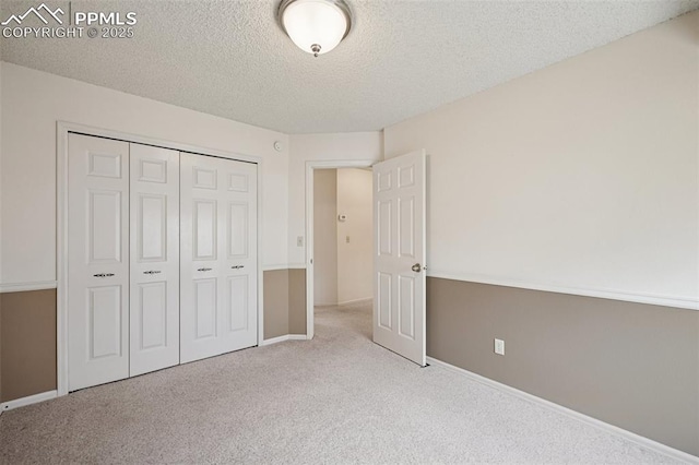 70 Palm Springs Dr, Colorado Springs, CO 80921 - unfurnished bedroom featuring carpet floors, a textured ceiling, baseboards, and a closet