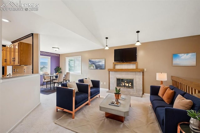 70 Palm Springs Dr, Colorado Springs, CO 80921 - living area with vaulted ceiling, a tiled fireplace, and baseboards