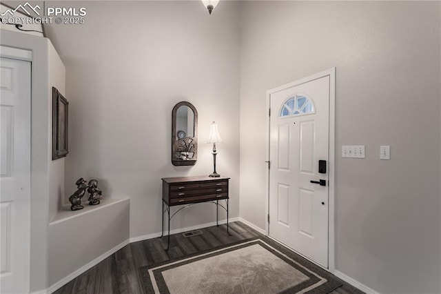 entryway featuring dark wood-type flooring and baseboards