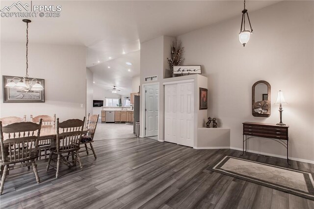 dining area featuring dark wood finished floors, a chandelier, high vaulted ceiling, baseboards, and a ceiling fan