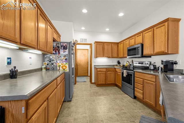 kitchen featuring a sink, brown cabinets, stainless steel appliances, visible vents, and recessed lighting