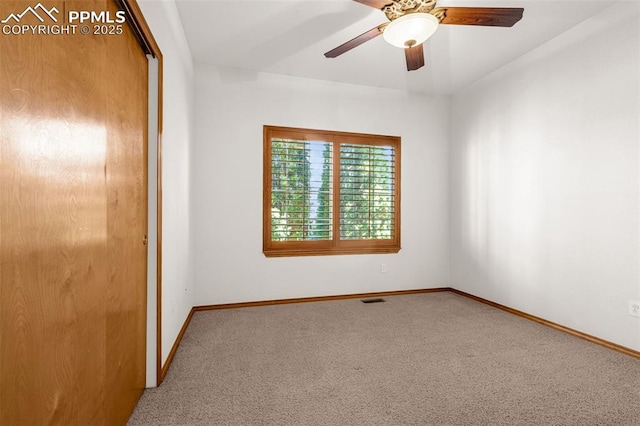 unfurnished bedroom featuring a ceiling fan, a closet, carpet, baseboards, and visible vents