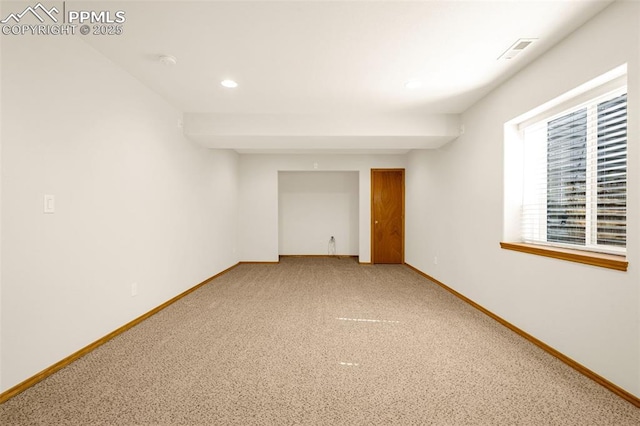 below grade area with baseboards, visible vents, recessed lighting, and carpet