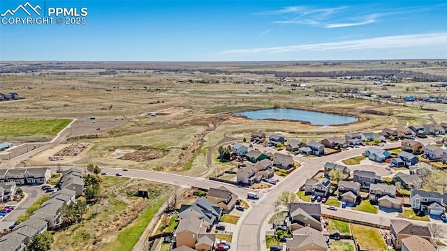 drone / aerial view featuring a residential view and a water view