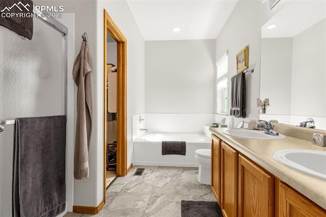 bathroom featuring a garden tub, a sink, a shower stall, and double vanity