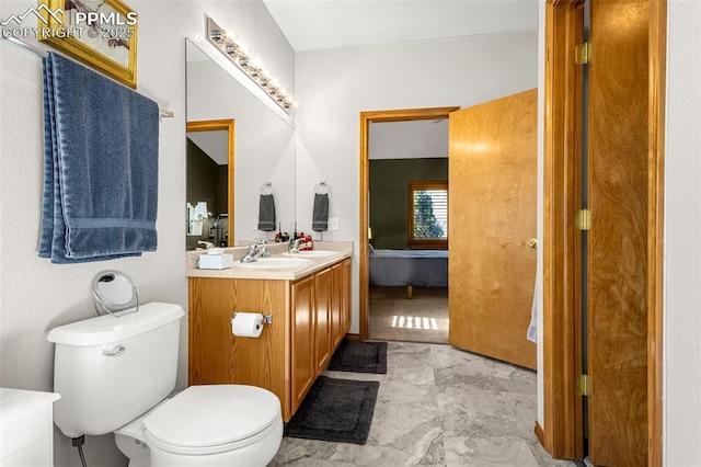 bathroom featuring toilet and vanity