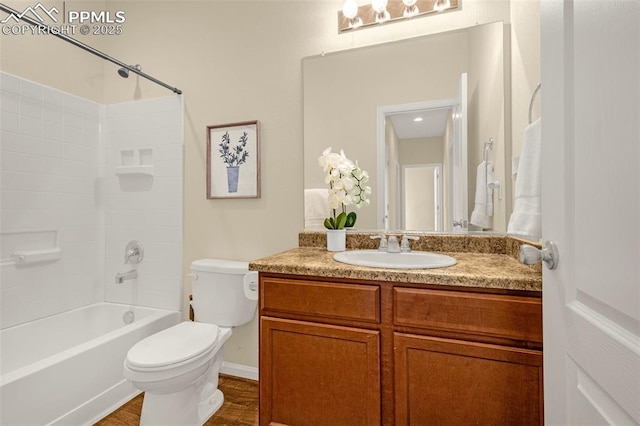 full bath featuring toilet, vanity, wood finished floors, and bathing tub / shower combination