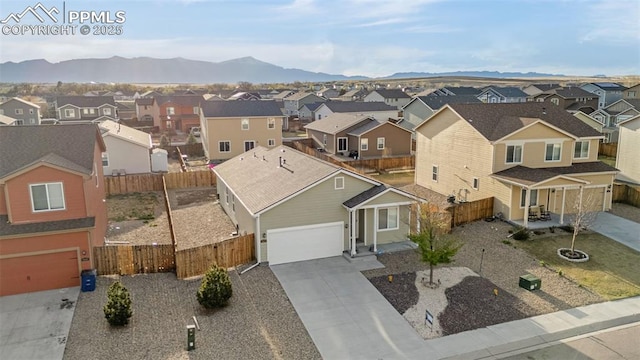 birds eye view of property featuring a mountain view and a residential view