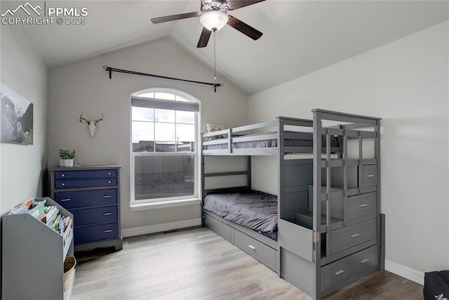 unfurnished bedroom featuring a ceiling fan, baseboards, lofted ceiling, and light wood-style floors