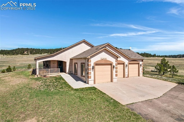 15930 Alta Plaza Cir, Peyton, CO 80831 - view of front of home featuring stucco siding, covered porch, an attached garage, a front yard, and concrete driveway