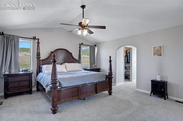 15930 Alta Plaza Cir, Peyton, CO 80831 - carpeted bedroom with arched walkways, lofted ceiling, a wood stove, and a ceiling fan
