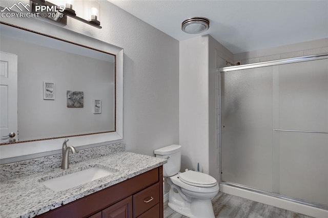 15930 Alta Plaza Cir, Peyton, CO 80831 - full bath with vanity, a shower stall, and wood finished floors