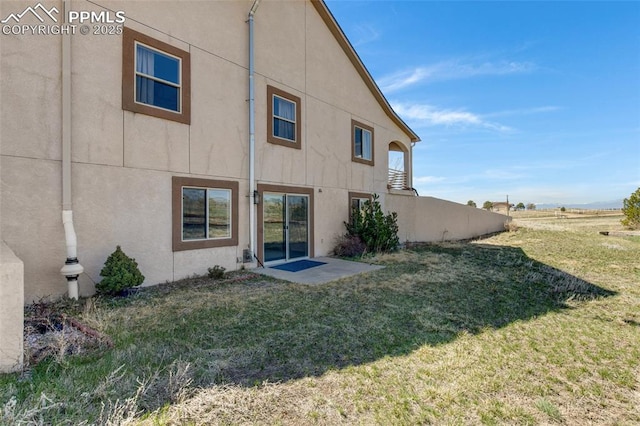 15930 Alta Plaza Cir, Peyton, CO 80831 - rear view of house with stucco siding and a yard