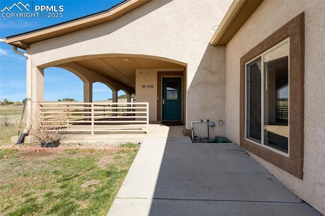 15930 Alta Plaza Cir, Peyton, CO 80831 - doorway to property with stucco siding and a patio area