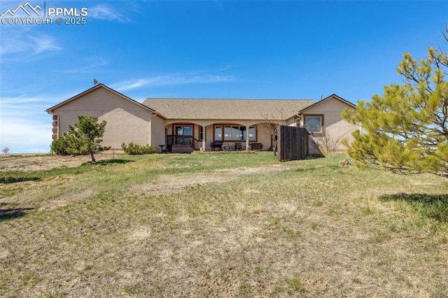 15930 Alta Plaza Cir, Peyton, CO 80831 - rear view of house featuring stucco siding and a lawn