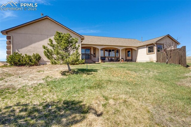15930 Alta Plaza Cir, Peyton, CO 80831 - rear view of house featuring a lawn, a porch, and stucco siding