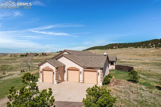 15930 Alta Plaza Cir, Peyton, CO 80831 - view of front of house featuring stucco siding, concrete driveway, an attached garage, and a shingled roof