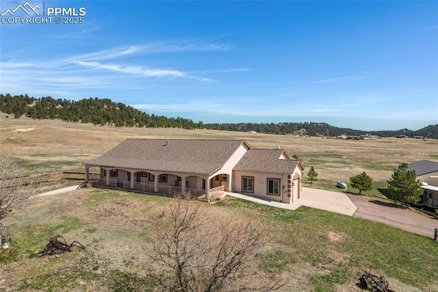 15930 Alta Plaza Cir, Peyton, CO 80831 - view of front of property with covered porch, concrete driveway, stucco siding, and a front yard