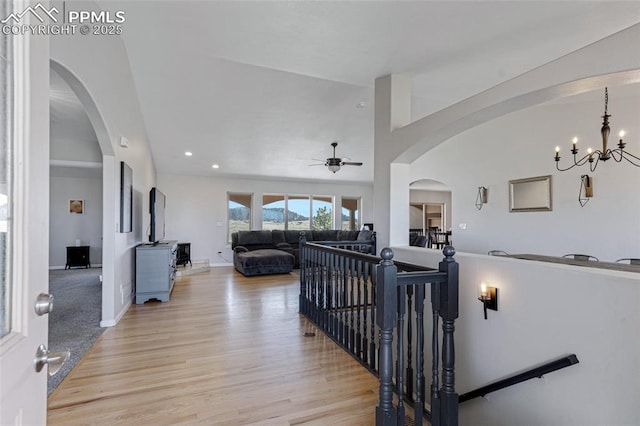 15930 Alta Plaza Cir, Peyton, CO 80831 - hallway with an upstairs landing, a chandelier, light wood-style floors, arched walkways, and recessed lighting