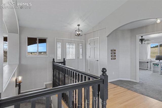 15930 Alta Plaza Cir, Peyton, CO 80831 - carpeted entryway featuring a ceiling fan, arched walkways, a chandelier, wood finished floors, and vaulted ceiling