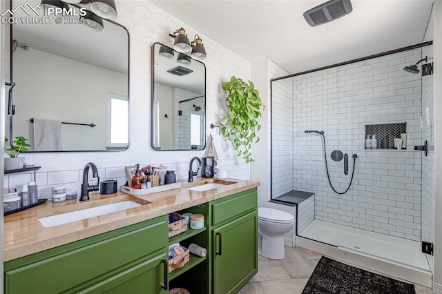 full bath with toilet, a sink, and a shower stall
