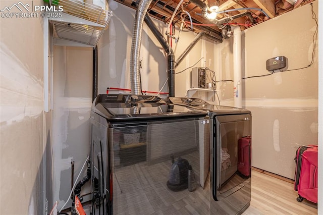 washroom featuring wood finished floors and washer and dryer
