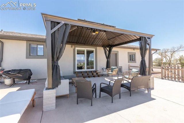 view of patio / terrace featuring outdoor lounge area, a gazebo, and fence