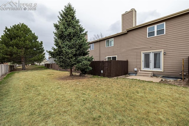 view of yard with fence and entry steps