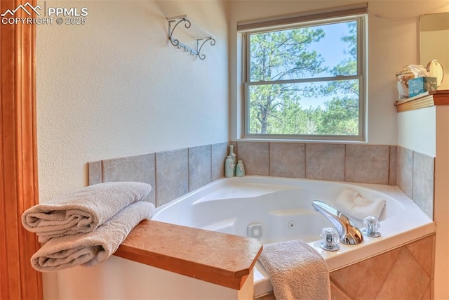 bathroom featuring a tub with jets