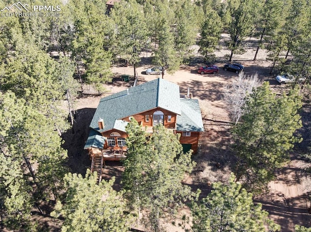 drone / aerial view featuring a forest view