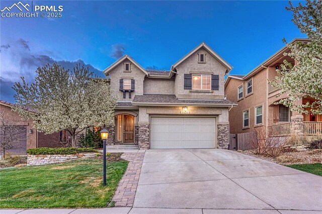 9539 Lizard Rock Trl, Colorado Springs, CO 80924 - traditional home featuring a garage, driveway, a front yard, and stucco siding