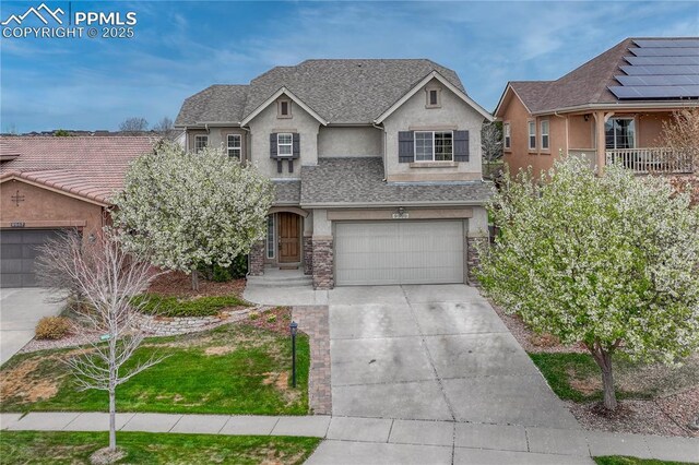 9539 Lizard Rock Trl, Colorado Springs, CO 80924 - view of front of property featuring stucco siding, an attached garage, and driveway