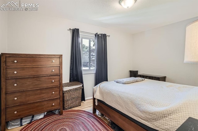 bedroom featuring light wood-style flooring