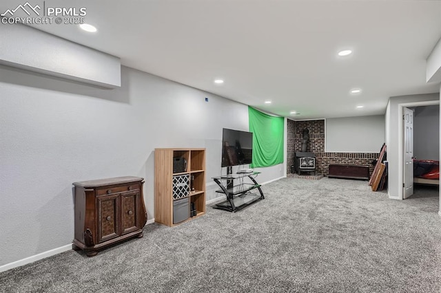 interior space with recessed lighting, a wood stove, carpet flooring, and baseboards