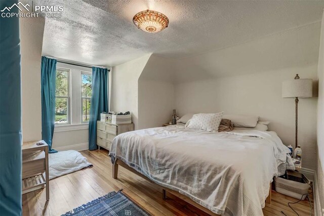519 W Bijou St, Colorado Springs, CO 80905 - bedroom with a textured ceiling, light wood-style flooring, and baseboards
