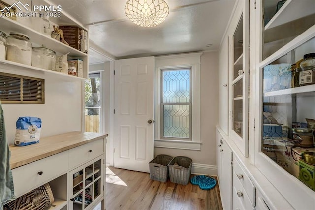 519 W Bijou St, Colorado Springs, CO 80905 - entryway with a chandelier, light wood-style flooring, and baseboards
