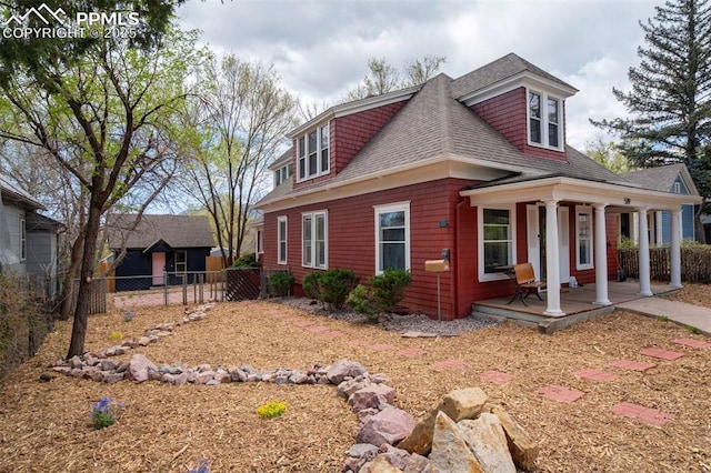 519 W Bijou St, Colorado Springs, CO 80905 - view of side of home with fence, a porch, and a shingled roof