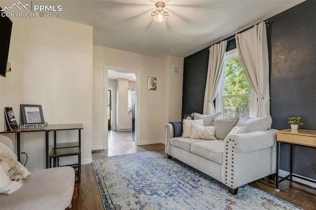 519 W Bijou St, Colorado Springs, CO 80905 - living area featuring visible vents, baseboards, and dark wood-type flooring