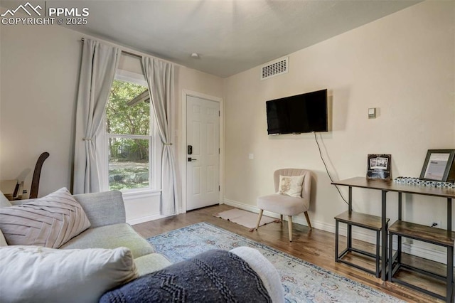 519 W Bijou St, Colorado Springs, CO 80905 - living room featuring baseboards, visible vents, and wood finished floors
